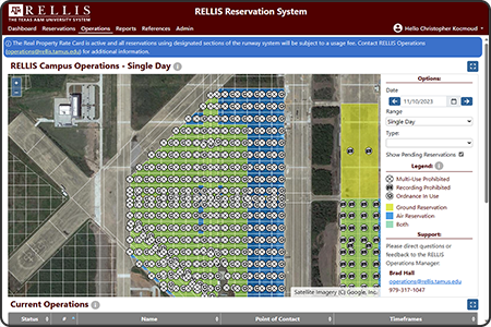 Screenshot of the RELLIS Reservation System (RRS) that tracks the current operations taking place across the RELLIS campus. The screenshot displays a aerial map of the campus with reserved 50 square meter reserved regions color-coded by ground or airspace and embedded with symbology indicating various limiting conditions.